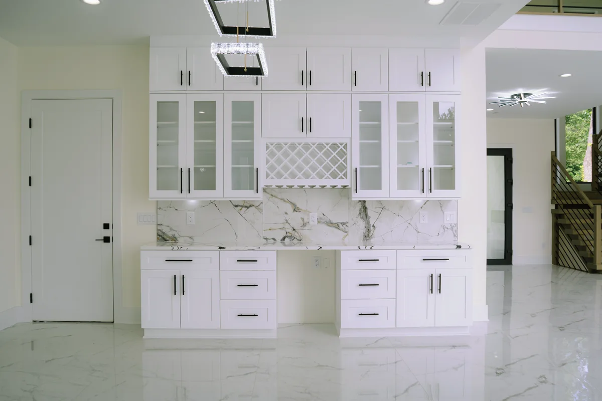Coffee and wine station with white glass-front cabinetry, a lattice wine rack, a marble-look slab backsplash, and polished porcelain floor