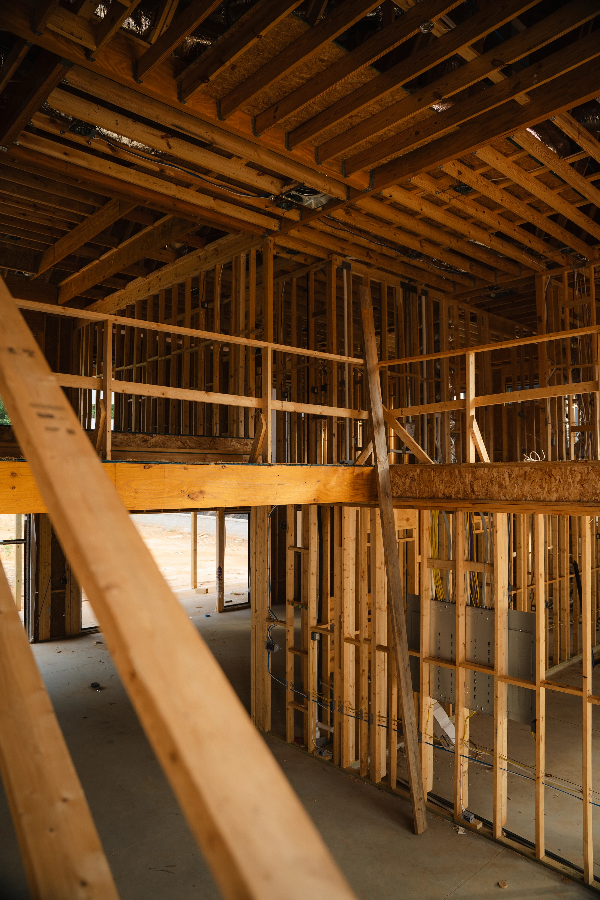 Two-level framed interior with a temporary diagonal brace and open floor structure.